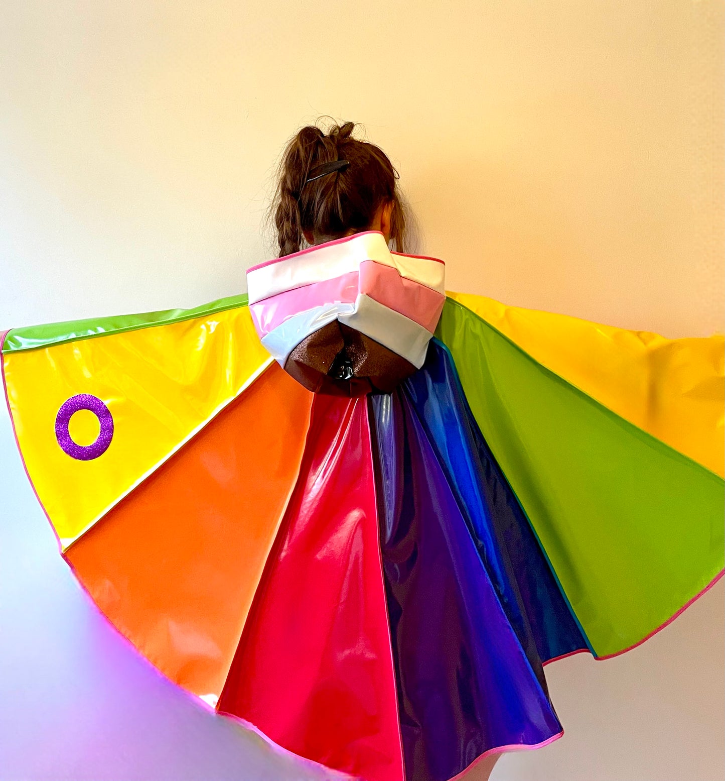 PRIDE cape: water-resistant cape. Feat. progress pride flag colours and intersex symbol.