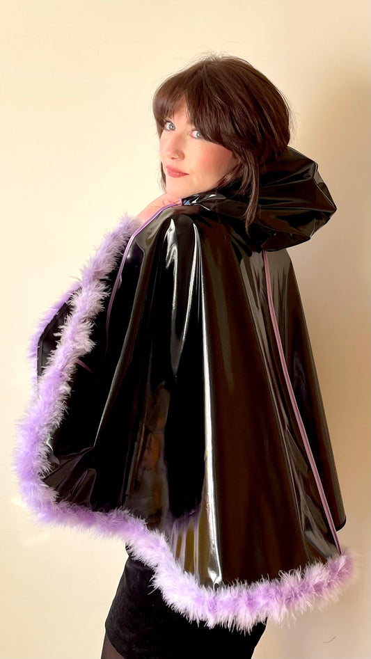 Black PVC 'CYCLONE' cape with lilac feather trim