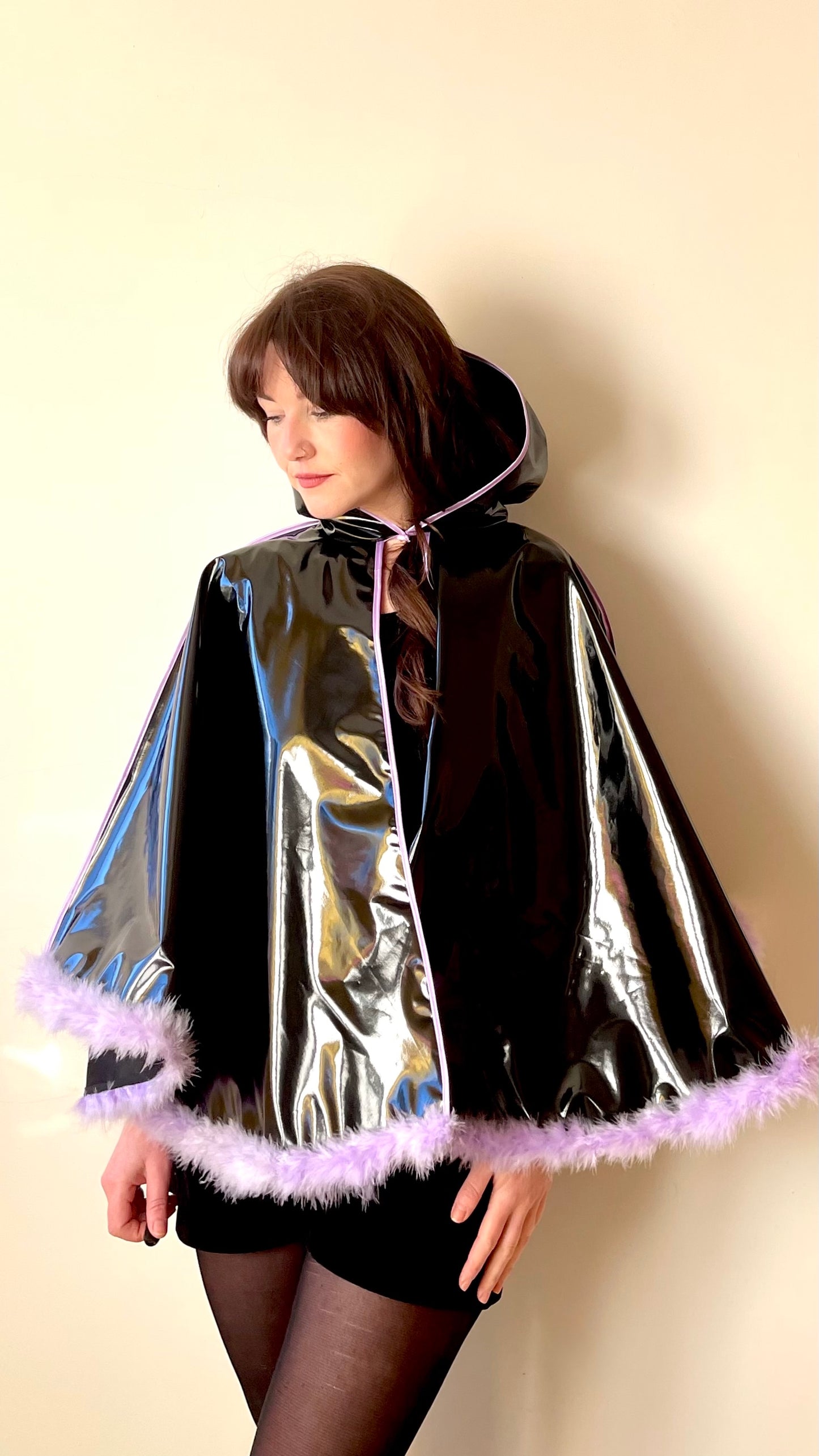 Black PVC 'CYCLONE' cape with lilac feather trim