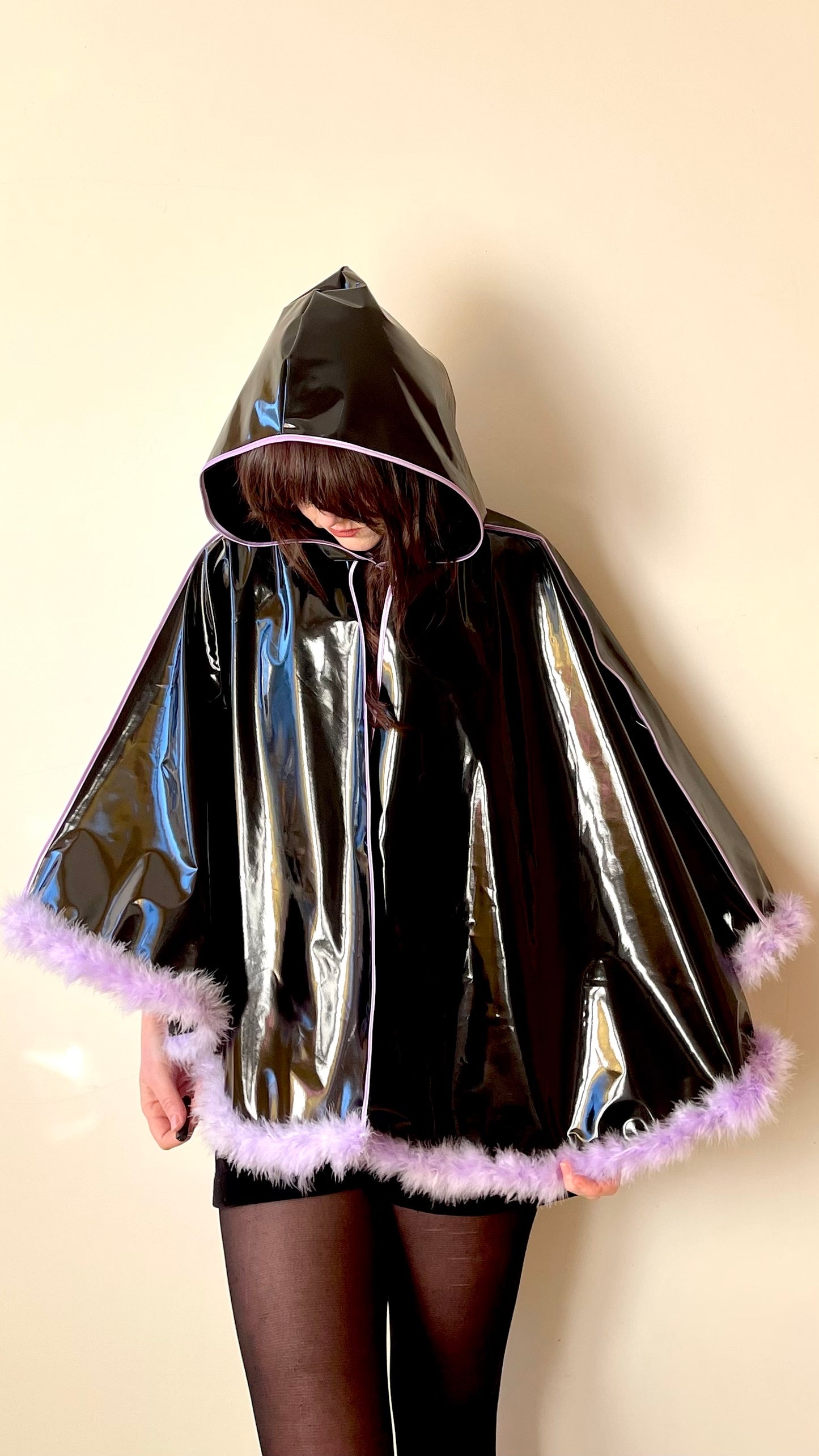 Black PVC 'CYCLONE' cape with lilac feather trim