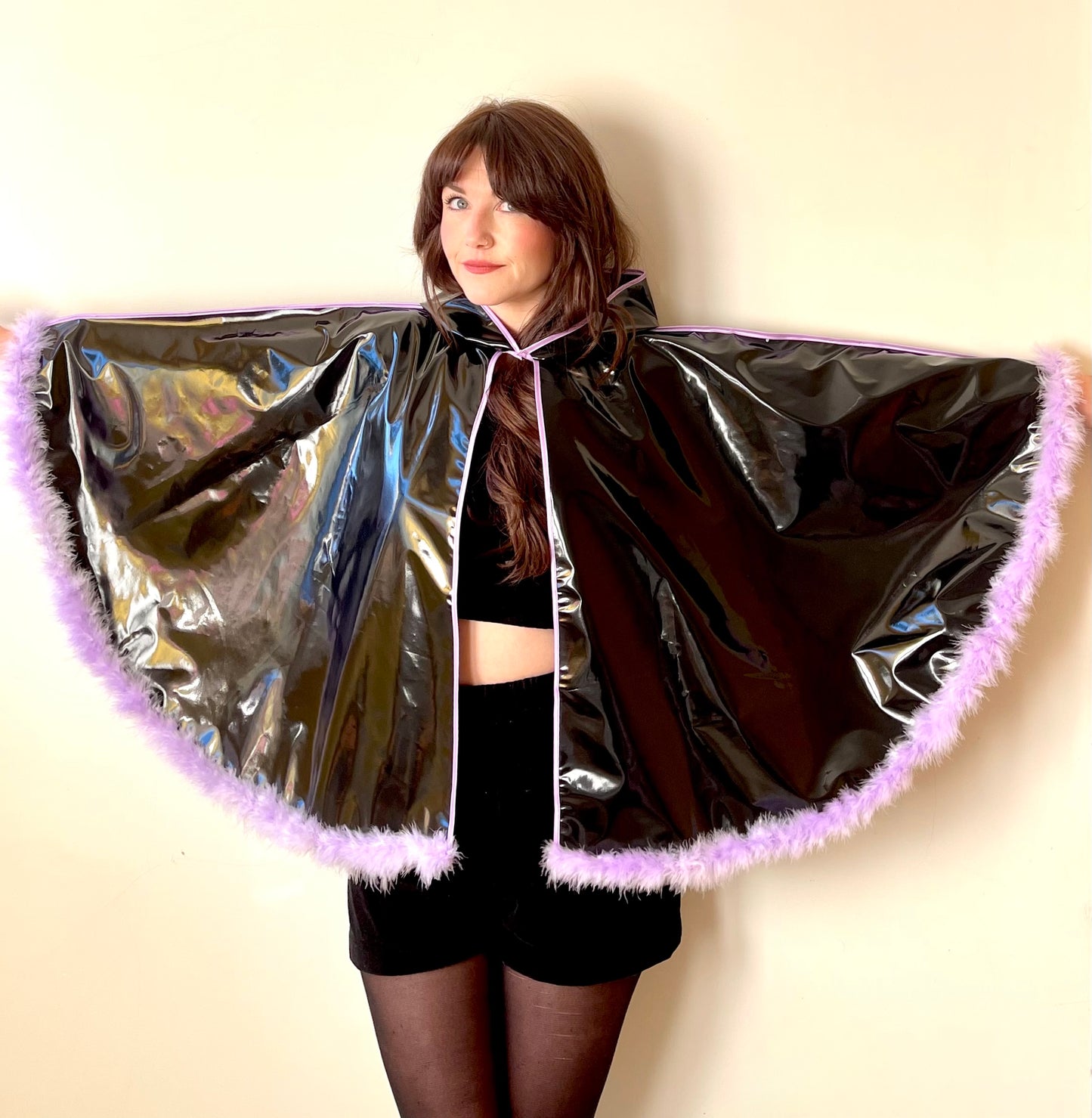 Black PVC 'CYCLONE' cape with lilac feather trim