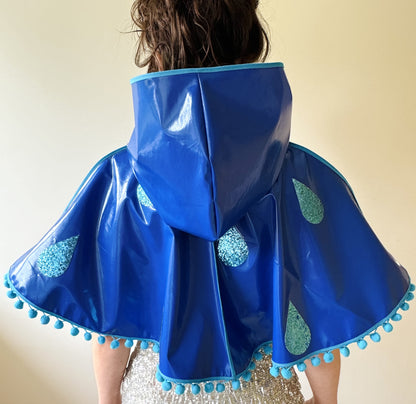 CYCLONE Blue cape, blue glitter raindrops & pompom trim