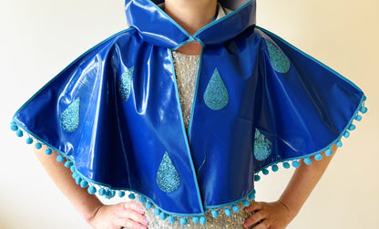 CYCLONE Blue cape, blue glitter raindrops & pompom trim