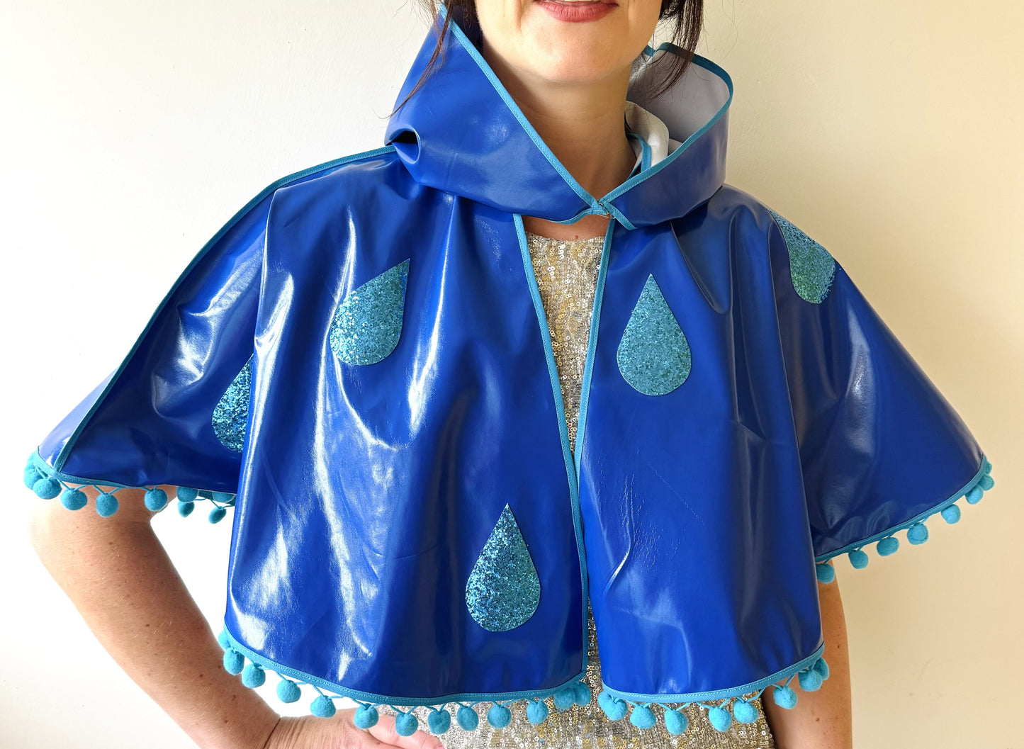 CYCLONE Blue cape, blue glitter raindrops & pompom trim