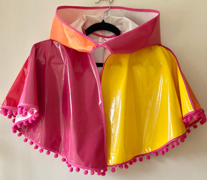 CYCLONE Sunset cape with pink pompoms