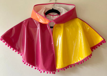 CYCLONE Sunset cape with pink pompoms