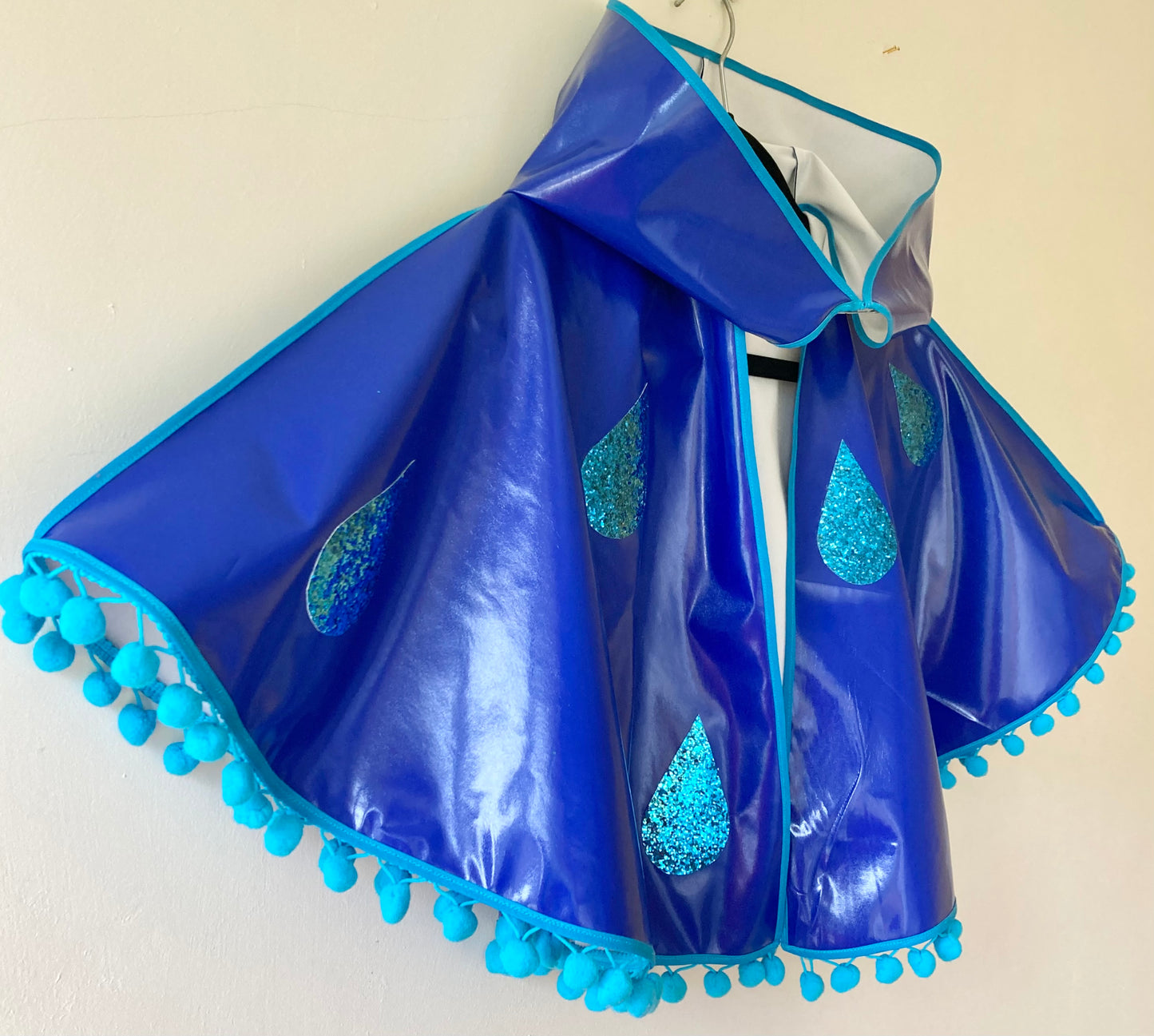 CYCLONE Blue cape, blue glitter raindrops & pompom trim