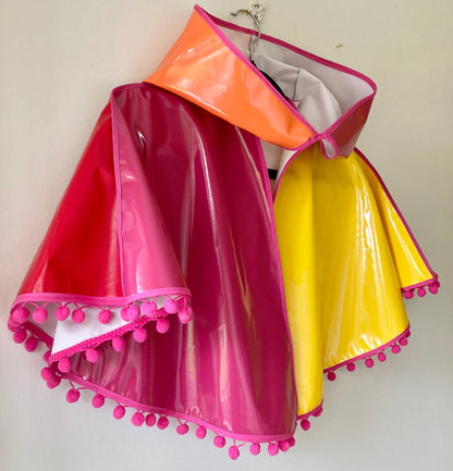 CYCLONE Sunset cape with pink pompoms