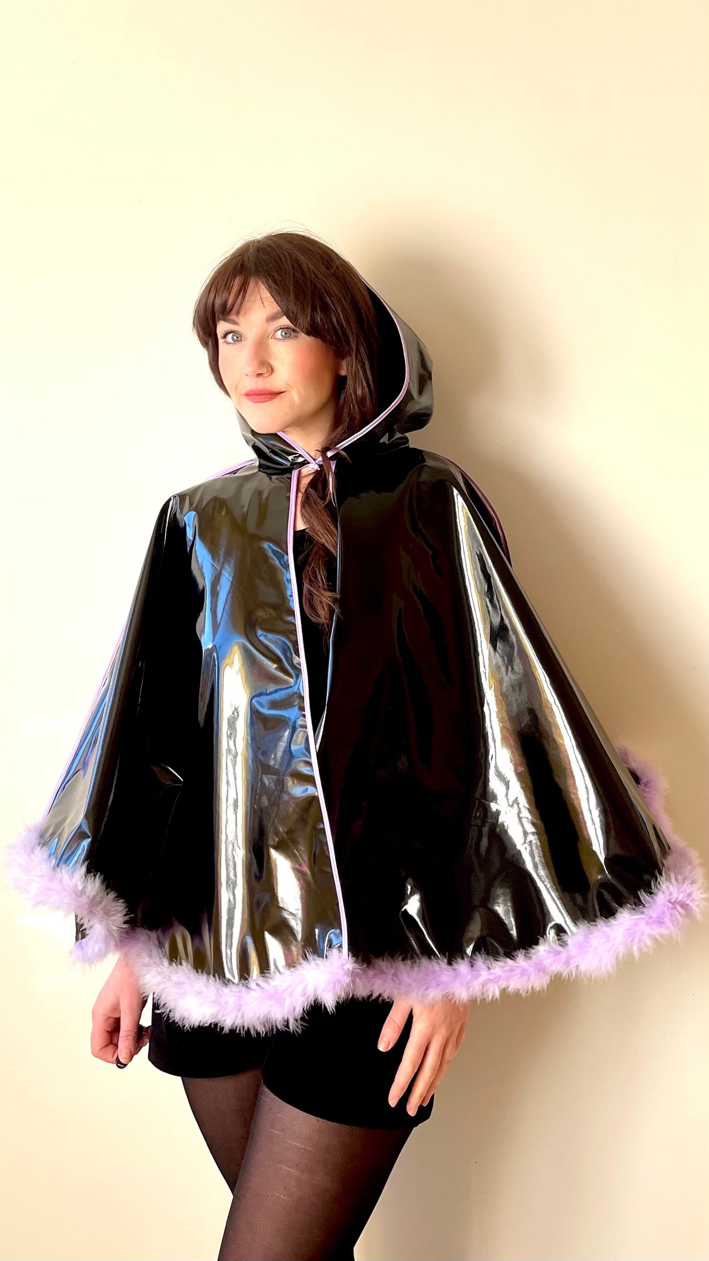 Black PVC 'CYCLONE' cape with lilac feather trim