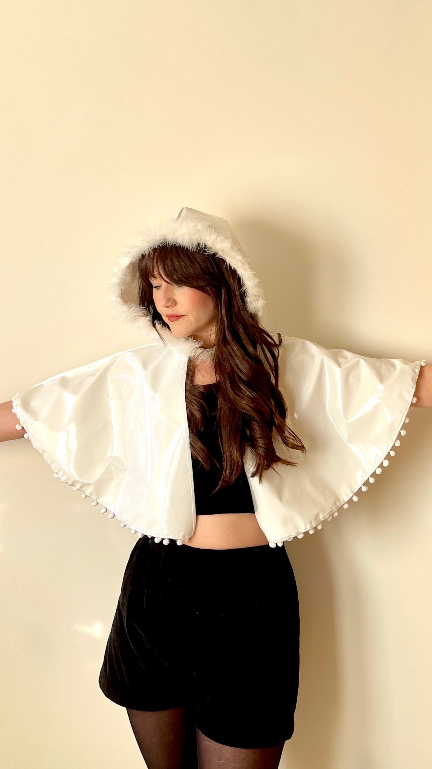 Frosty white 'CYCLONE' cape with feather and pom pom trim