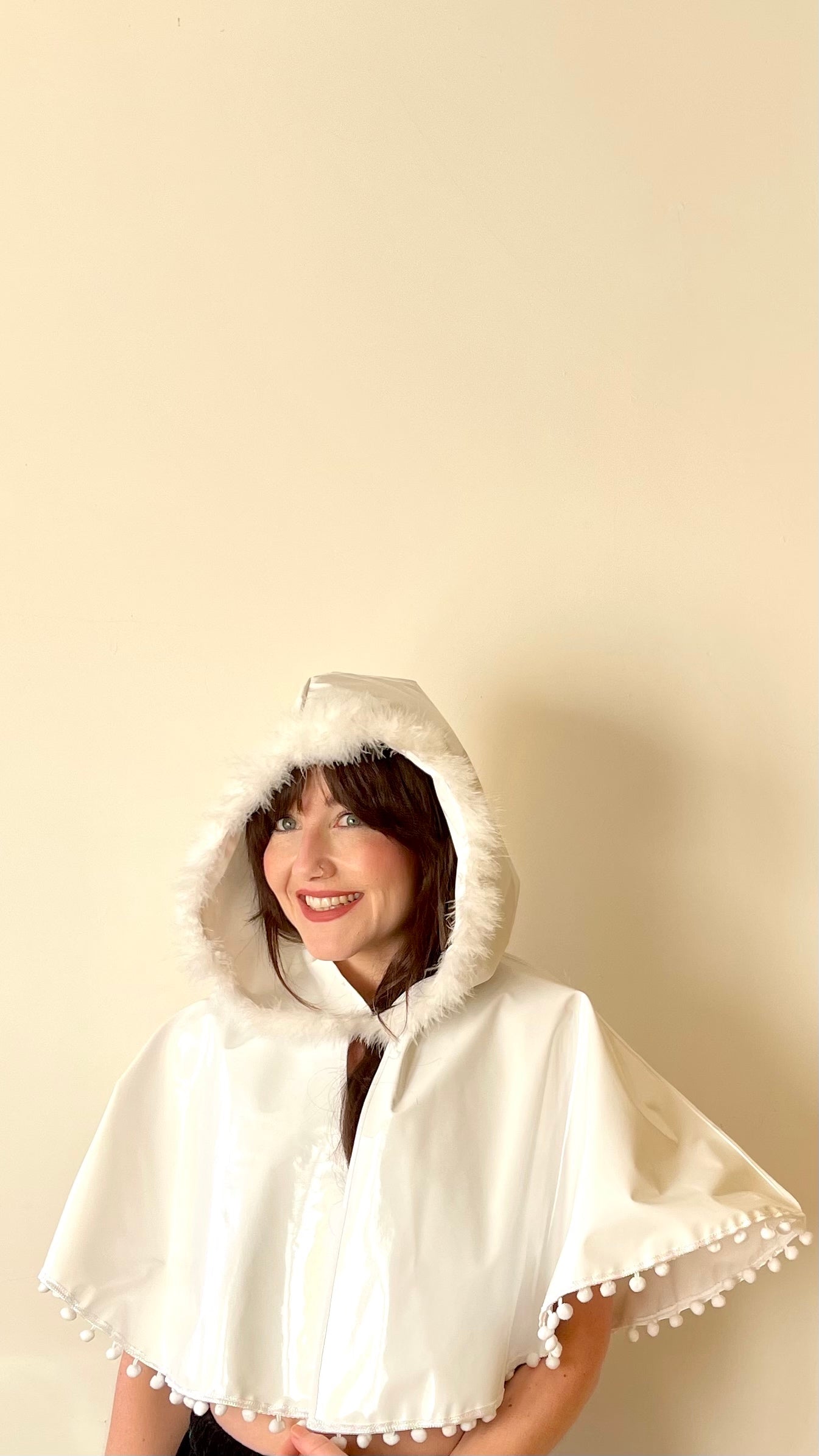 Frosty white 'CYCLONE' cape with feather and pom pom trim