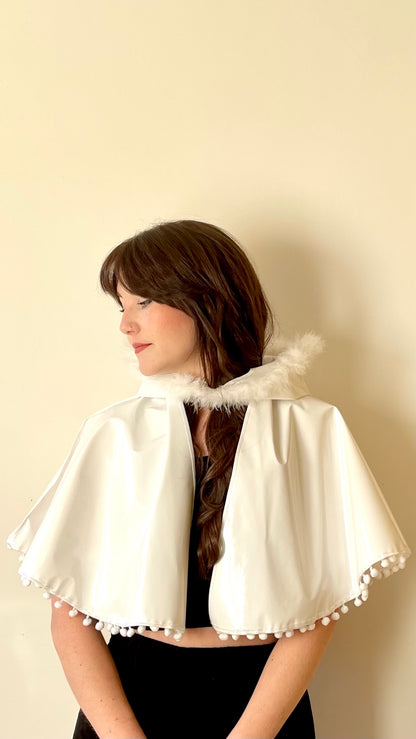 Frosty white 'CYCLONE' cape with feather and pom pom trim