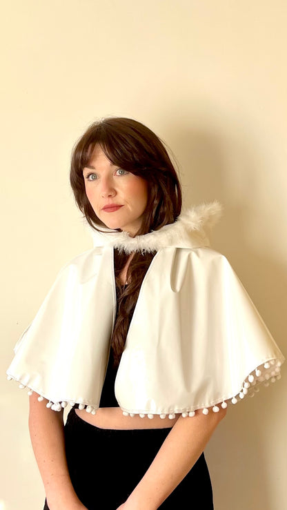 Frosty white 'CYCLONE' cape with feather and pom pom trim