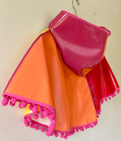 CYCLONE Sunset cape with pink pompoms